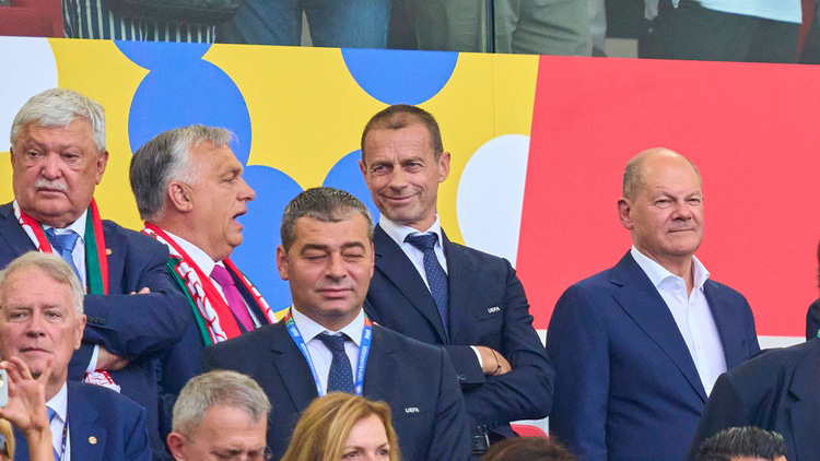 Hungarian Prime Minister Viktor Orban chats to UEFA president Aleksander Ceferin