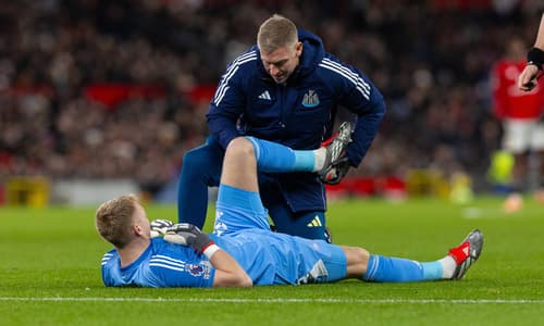 Newcastle goalkeeper Aaron Ramsdale receives treatment for an injury against Manchester United
