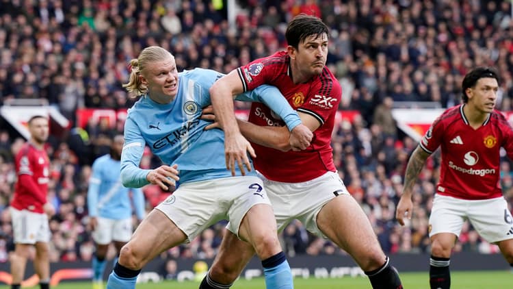 Harry Maguire (right) challenges Erling Haaland