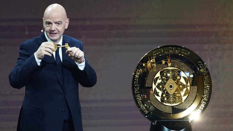 FIFA boss Gianni Infantino and the Club World Cup trophy