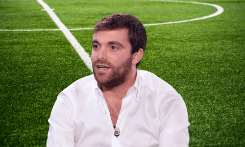 Headshot of Fabrizio Romano in front of a football pitch background