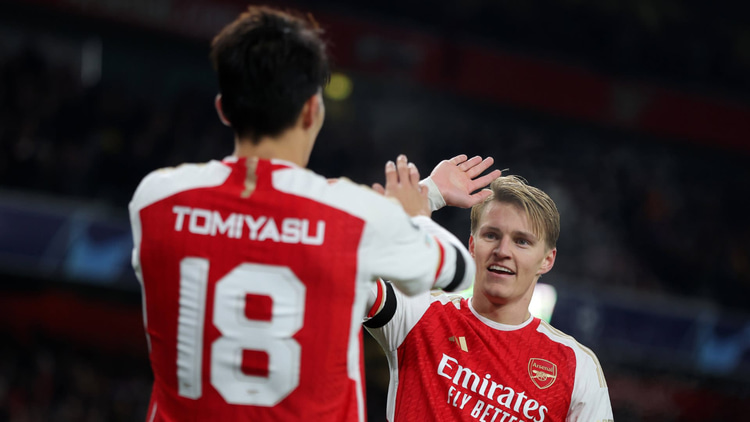 Takehiro Tomiyasu and Martin Odegaard celebrate a goal against Lens in the Champions League
