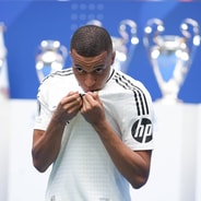 Kylian Mbappe kisses the Real Madrid badge at his presentation, 2024