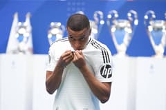 Kylian Mbappe kisses the Real Madrid badge at his presentation, 2024