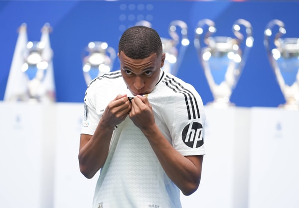 Kylian Mbappe kisses the Real Madrid badge at his presentation, 2024