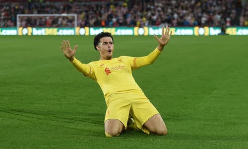 Curtis Jones celebrates scoring a goal for Liverpool in a Premier League match at Brentford Community Stadium against Brentford in 2021