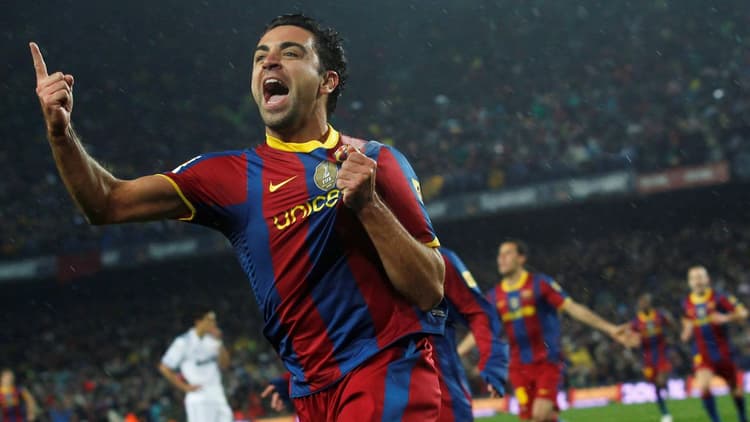 Xavi celebrates scoring against Real Madrid