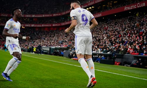 Benzema and Vinicius celebrate a Real Madrid goal in a LaLiga match vs Athletic.