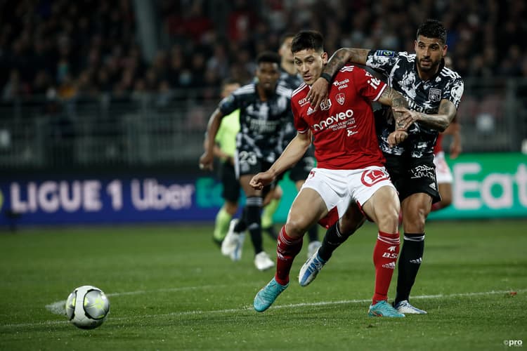 Martin Satriano of Brest holds off Lyon defender Emerson
