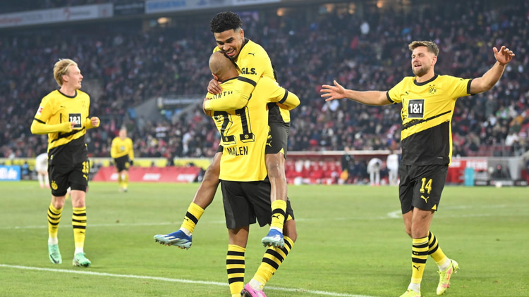 Ian Maatsen celebrates with Donyell Malen against Koln