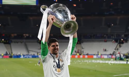 Thibaut Courtois of Real Madrid lifts the Champions League trophy.