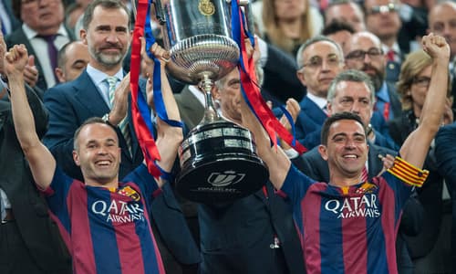 Andres Iniesta and Xavi lift trophy together for Barcelona