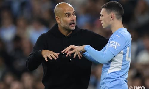 Man City boss Pep Guardiola chats to Phil Foden during a Champions League tie with PSG