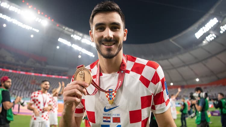 Sutalo with his bronze medal at the 2022 World Cup