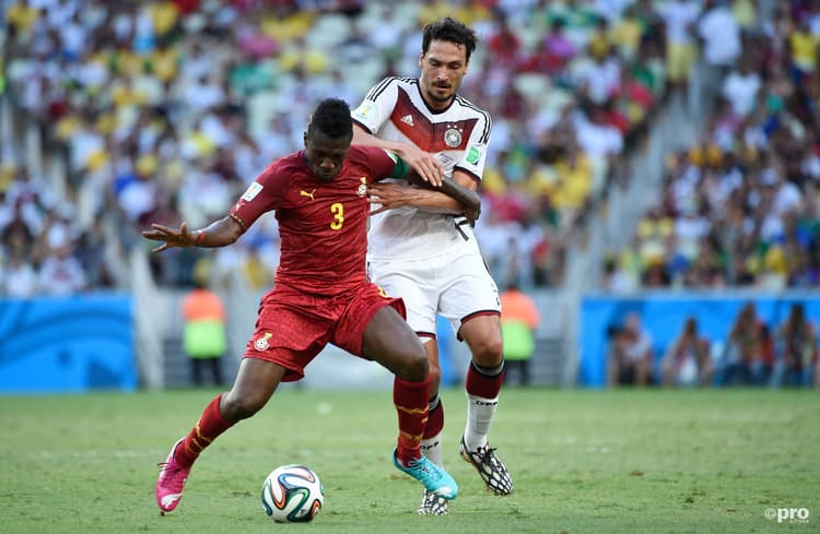 Asamoah Gyan (left) playing for Ghana against Germany at World Cup 2014