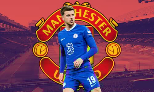Mason Mount of Chelsea over the Manchester United badge, set against a backdrop of a panorama of Old Trafford in red