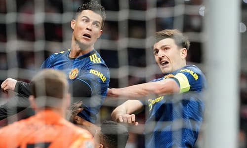 Cristiano Ronaldo and Harry Maguire leaping for the same ball at Man Utd.