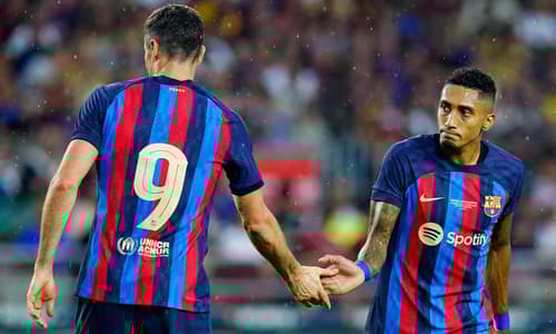 Robert Lewandowski and Raphinha in action for Barcelona in pre-season.