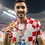 Josip Sutalo of Dinamo Zagreb and Croatia celebrates with his third place medal at the World Cup 2022