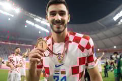 Josip Sutalo of Dinamo Zagreb and Croatia celebrates with his third place medal at the World Cup 2022