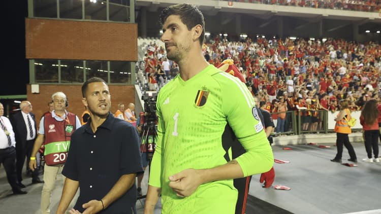 Courtois talks to Eden Hazard after Belgium's draw with Austria in Brussels on Saturday