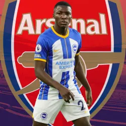 Moises Caicedo of Brighton in front of the Arsenal badge, set against a backdrop of a panorama of the Emirates Stadium in red