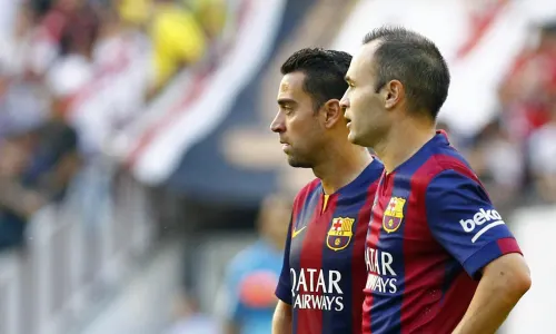 Xavi and Iniesta in action for Barcelona.