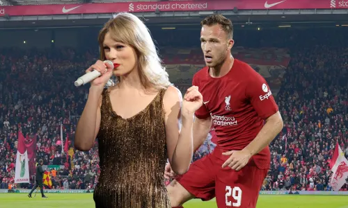 Taylor Swift and Arthur Melo in front of a view of the Kop at Anfield