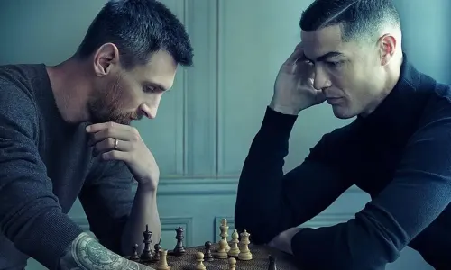 Lionel Messi and Cristiano Ronaldo playing chess.