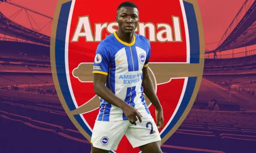 Moises Caicedo of Brighton in front of the Arsenal badge, set against a backdrop of a panorama of the Emirates Stadium in red