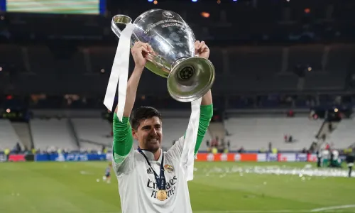 Thibaut Courtois of Real Madrid lifts the Champions League trophy.