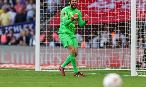 Alisson celebrates as Liverpool win the FA Cup on penalties.