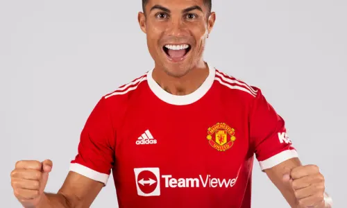 Cristiano Ronaldo poses in the Manchester United home kit for the 2021/22 season