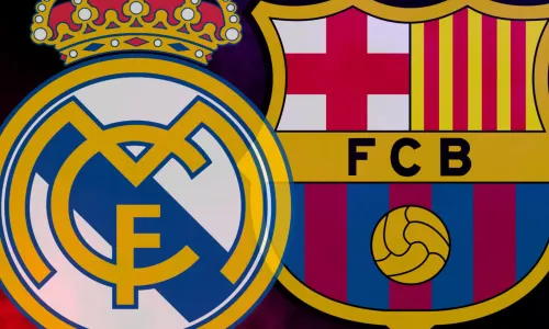 The Real Madrid and Barcelona badges on a red and blue smoky background
