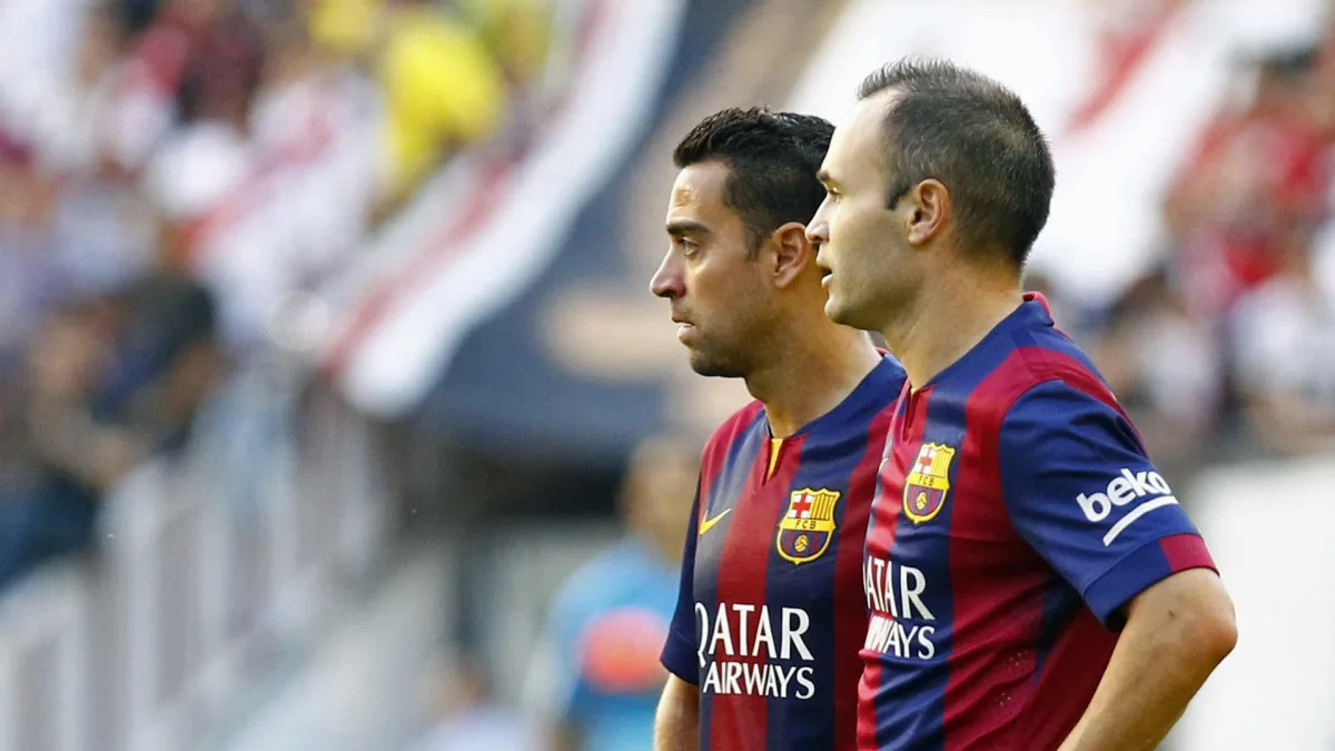 Xavi and Iniesta in action for Barcelona.