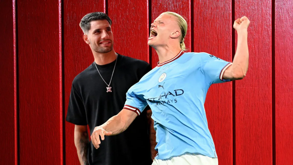 Domink Szoboszlai and Erling Haaland in front of a red fence background