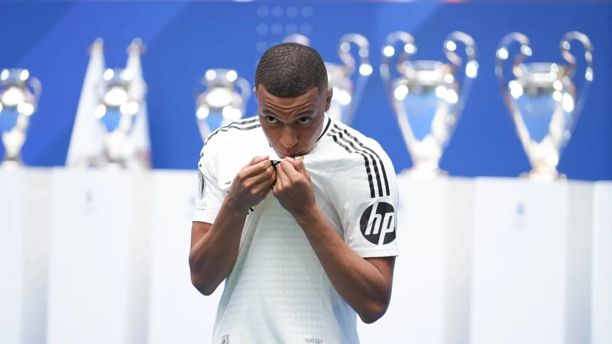 Kylian Mbappe kisses the Real Madrid badge at his presentation, 2024