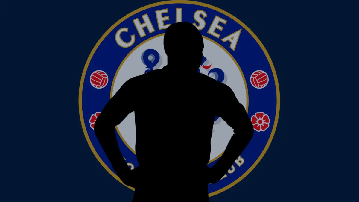A silhouette of N'Golo Kante over the Chelsea badge on a plain dark blue background