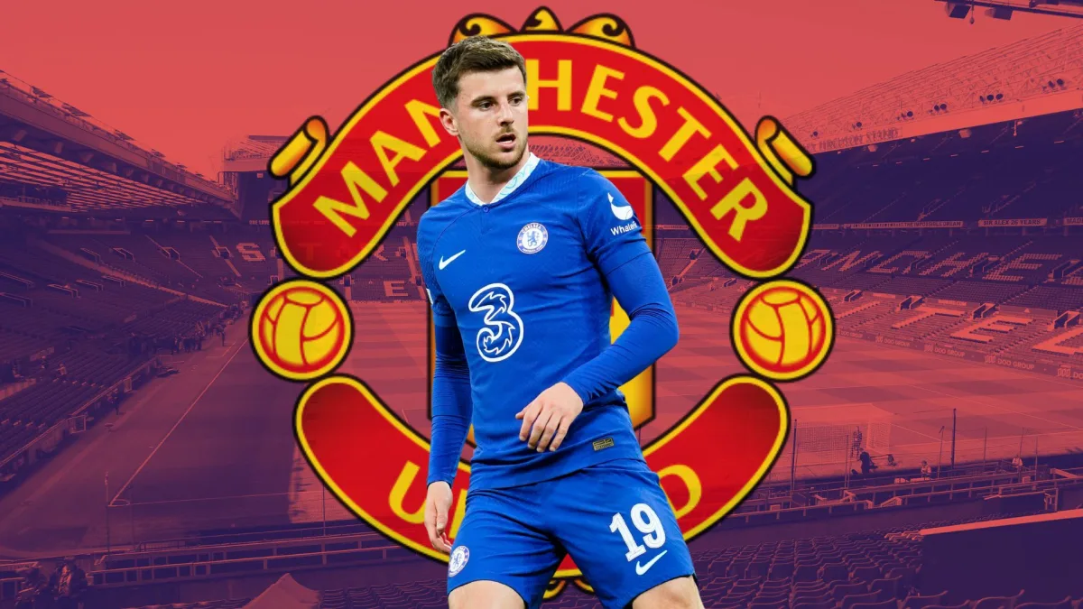 Mason Mount of Chelsea over the Manchester United badge, set against a backdrop of a panorama of Old Trafford in red