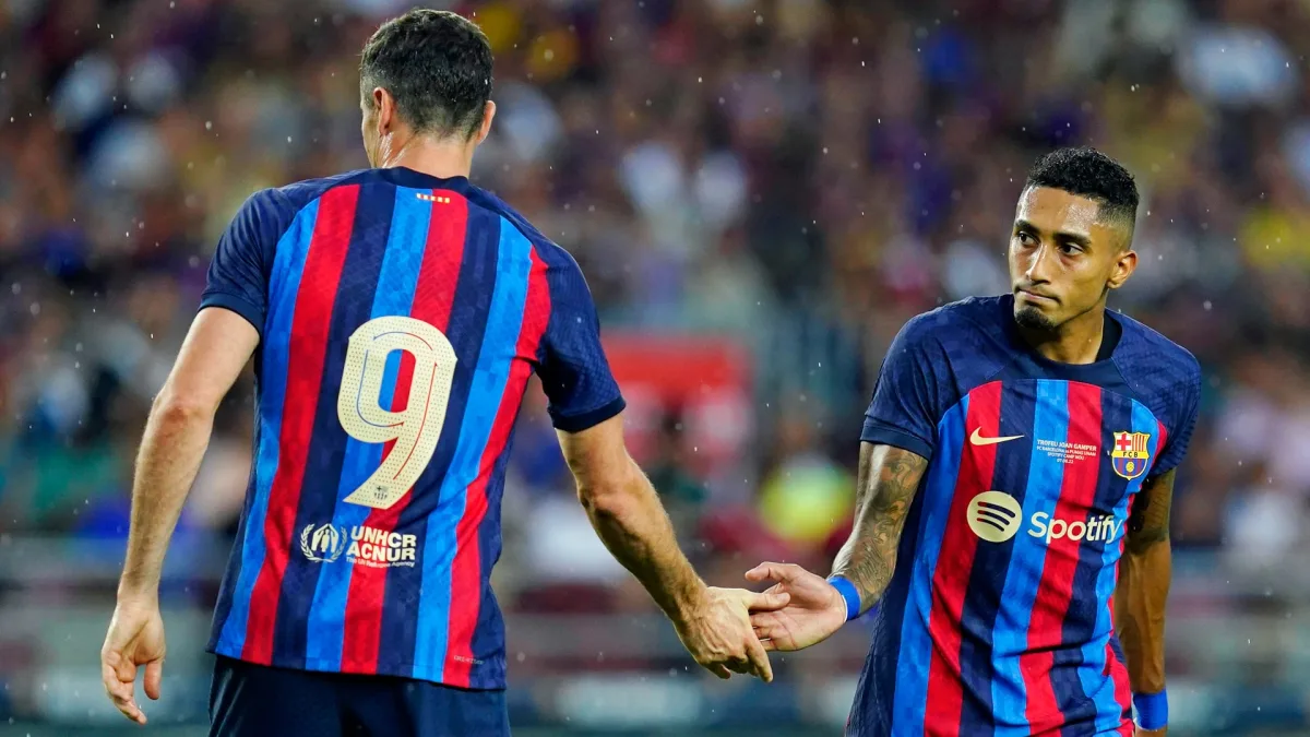 Robert Lewandowski and Raphinha in action for Barcelona in pre-season.