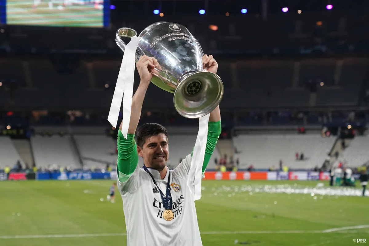 Thibaut Courtois of Real Madrid lifts the Champions League trophy.