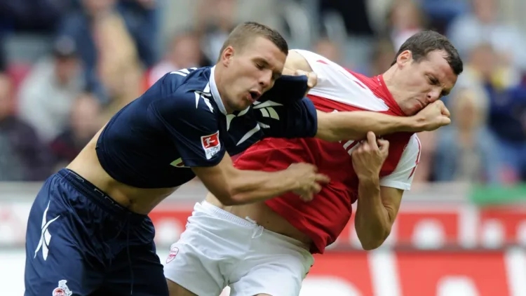 Lukas Podolski and Sebastian Squillaci squaring up in a friendly