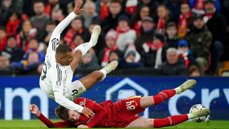 Kylian Mbappe gets tackled by Conor Bradley