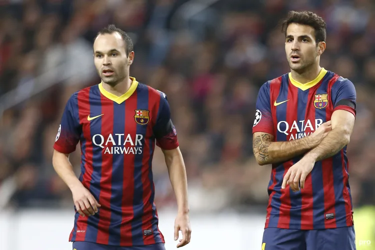 Cesc Fabregas and Andres Iniesta playing for Barcelona against Ajax in the Champions League in 2013/14